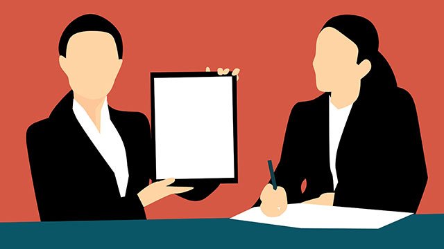 Woman in business meeting holding up a tablet